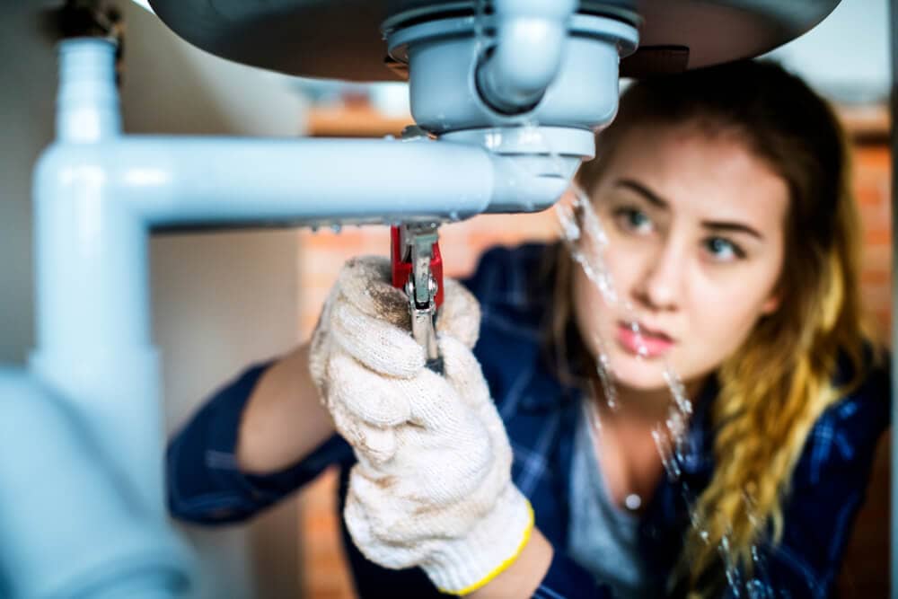 woman doing plumbing work