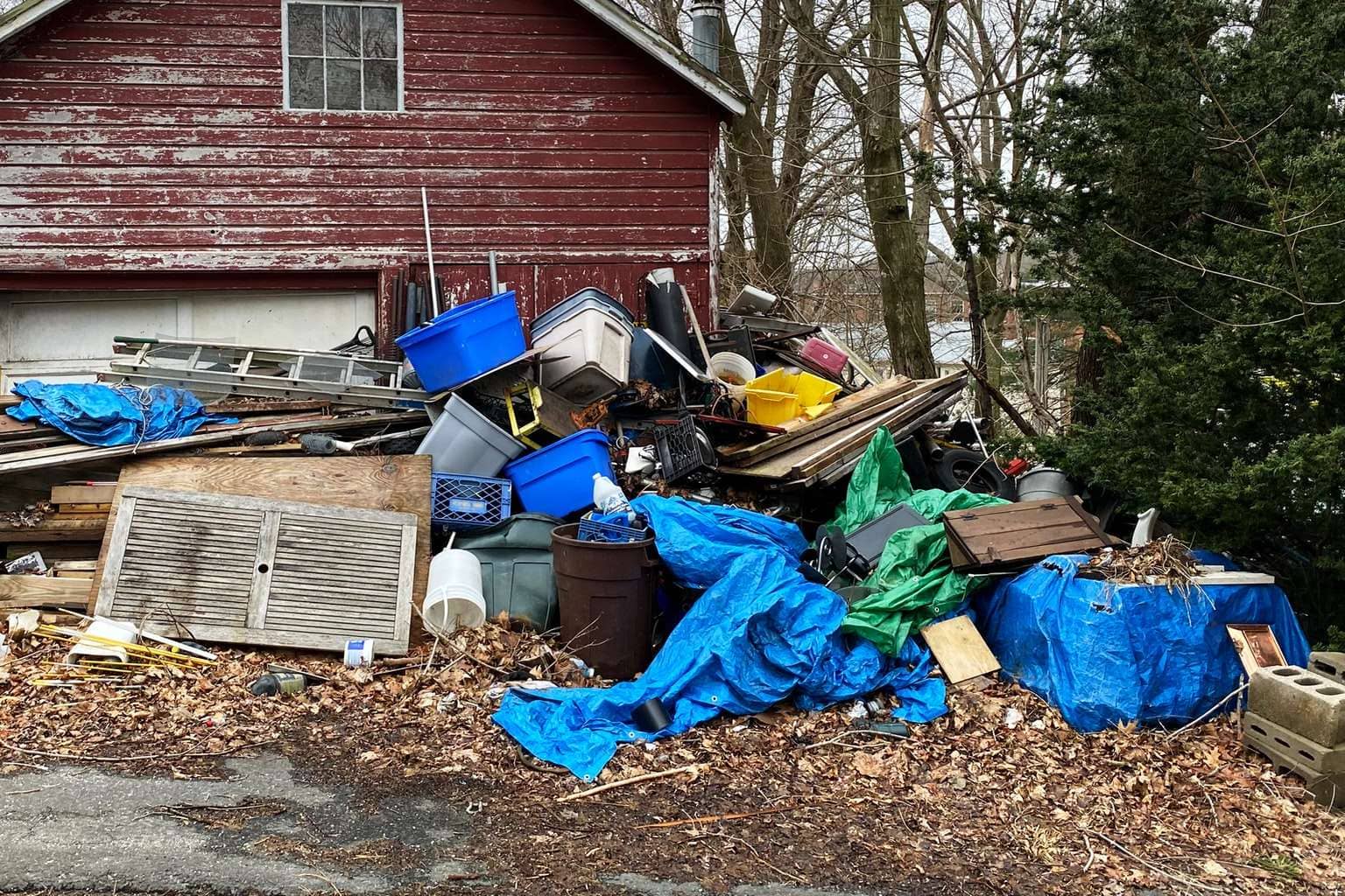 junk piled in front of house
